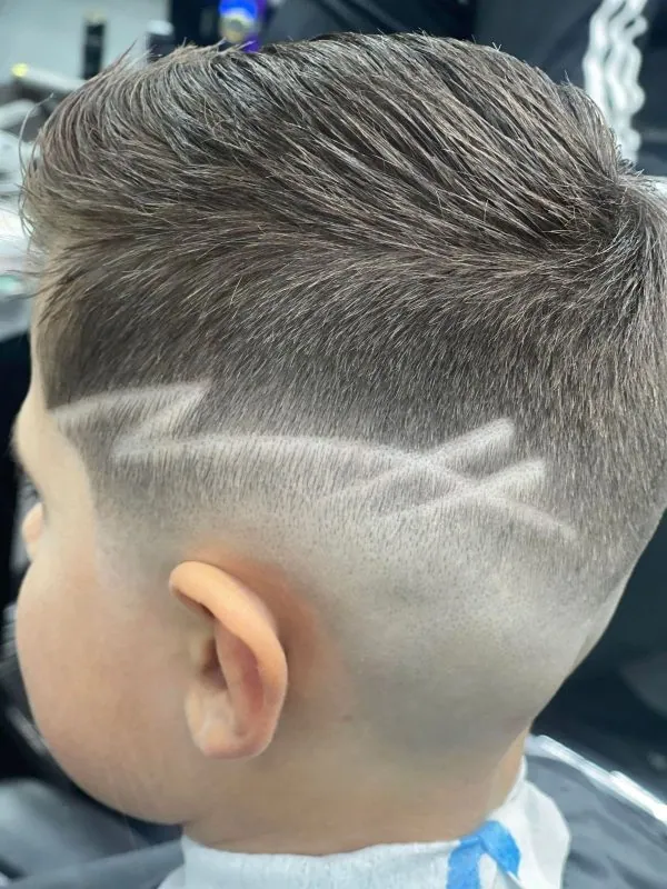 Close-up of a fade with a shaved line detail at Iconic Cuts